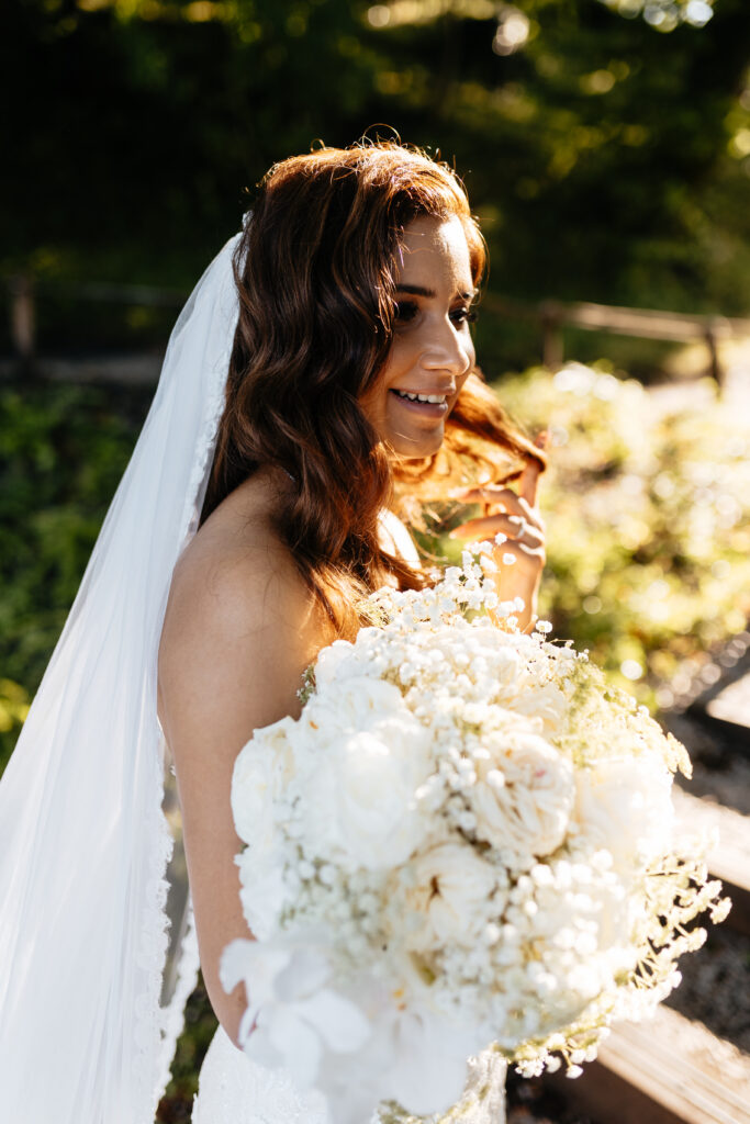 Portrait of a bride holding her bouquet in golden evening light