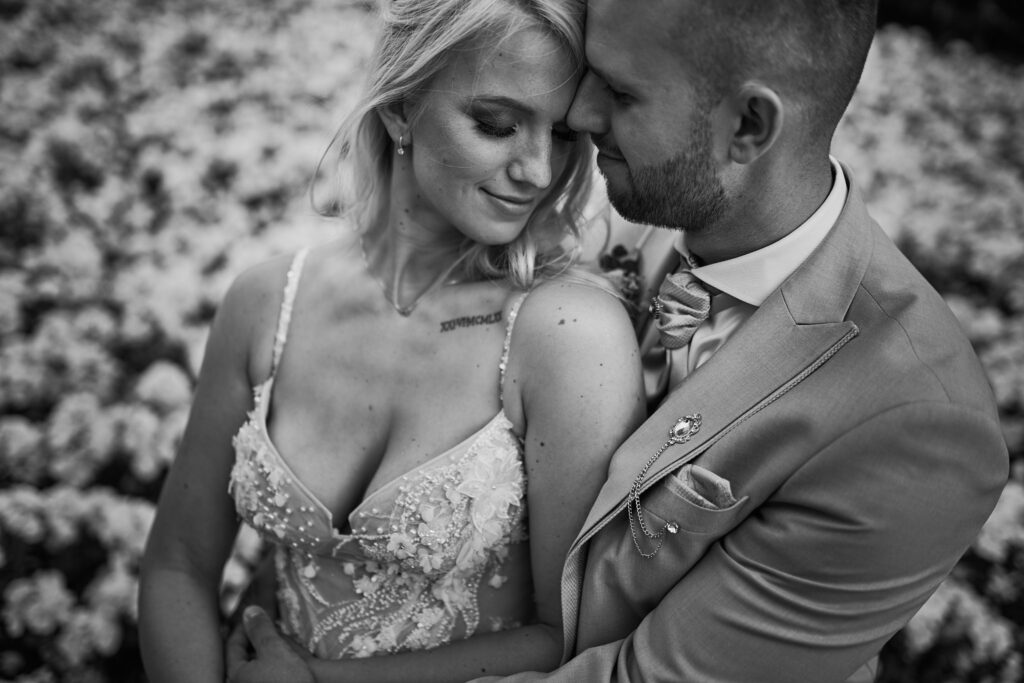 Black and white portrait of a bride and groom embracing at Bled Rose Hotel