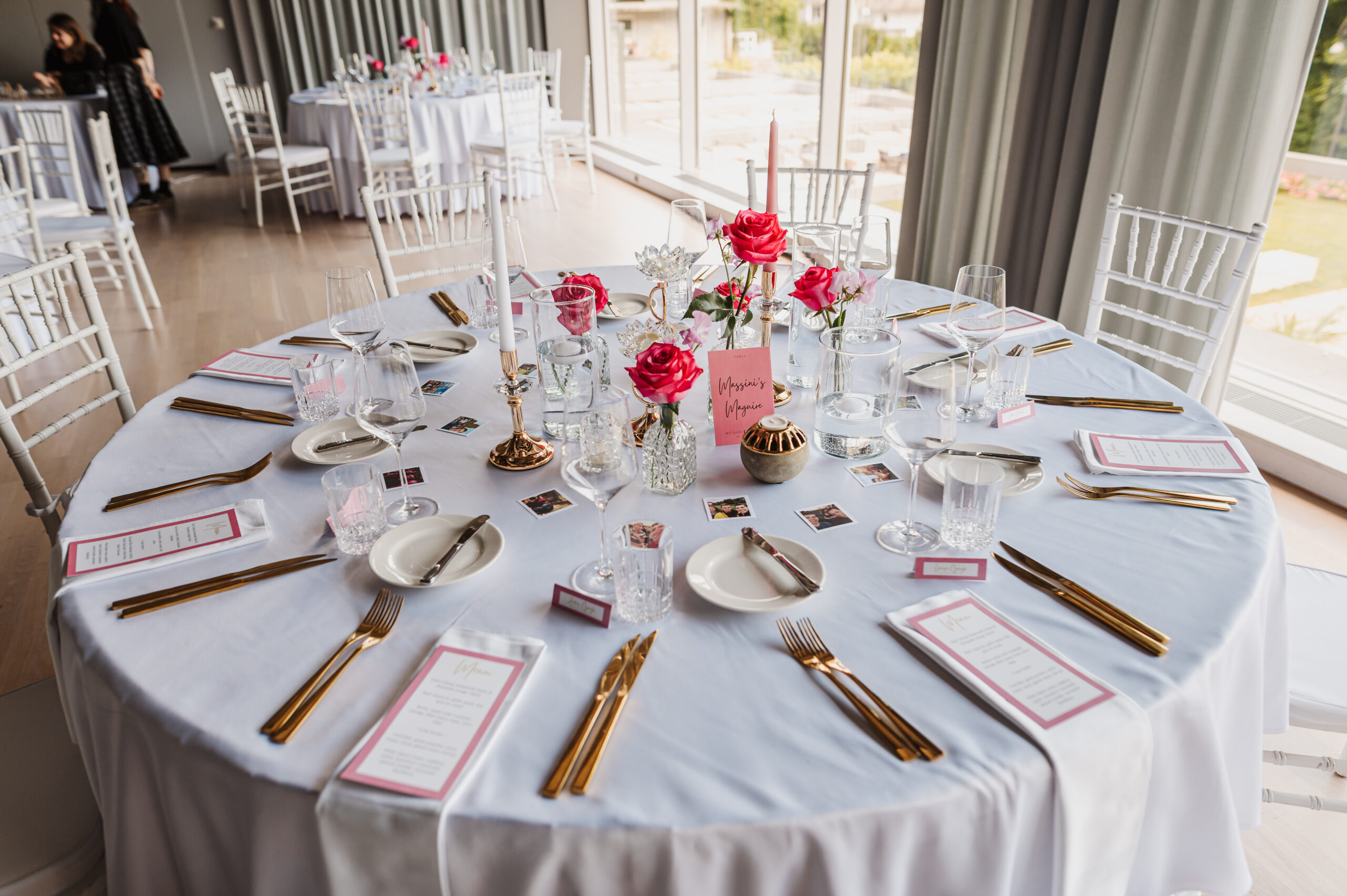 Long wedding head table with gold cutlery and white floral decoration