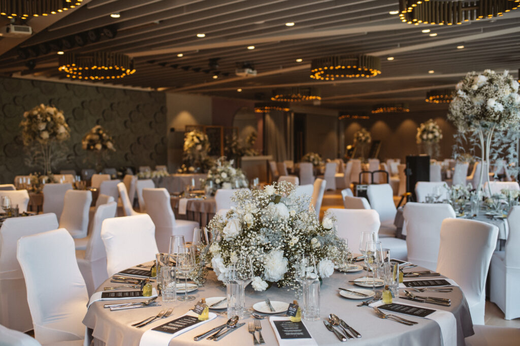 Wedding head table in front of the signature rose relief wall at Bled Rose Hotel