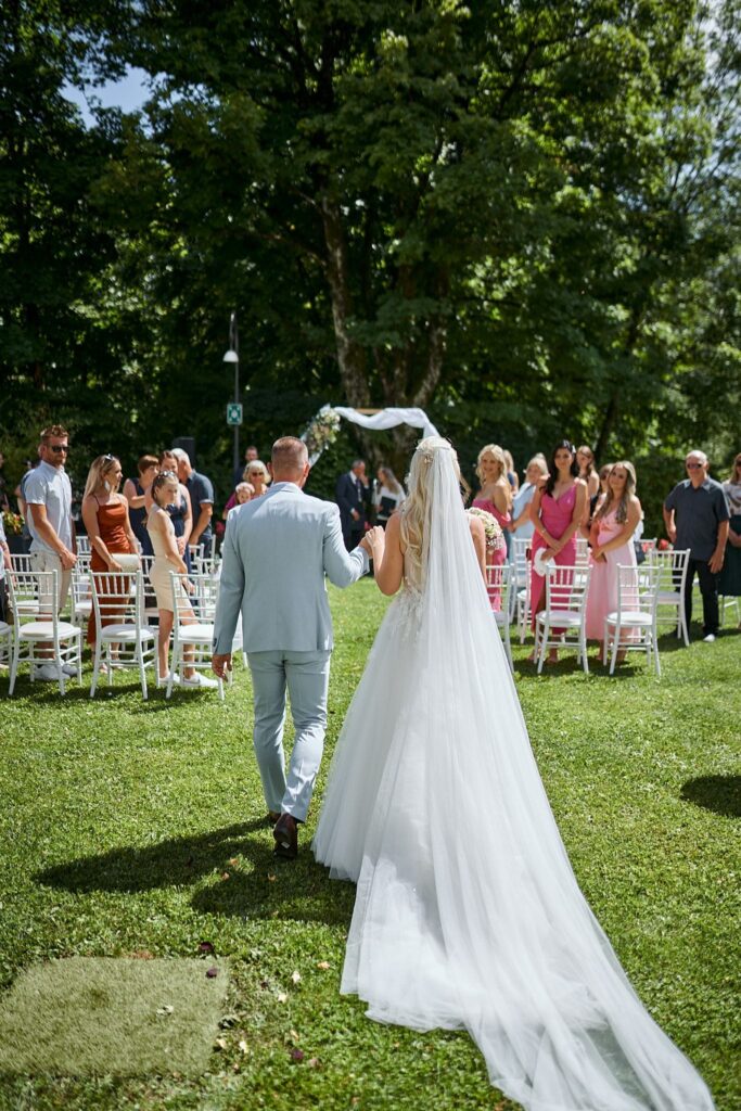 Garden wedding ceremony at Bled Rose Hotel with the Julian Alps behind