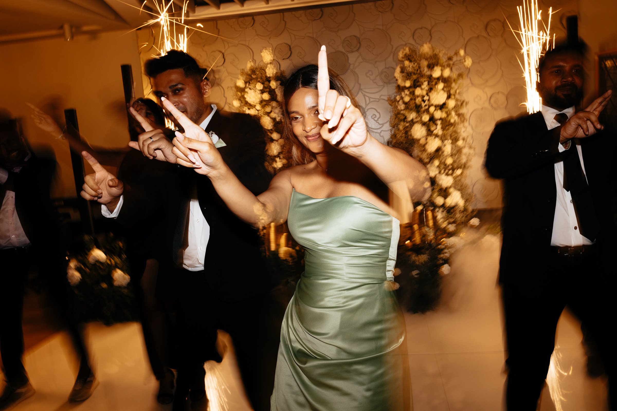 Newlyweds entering the Rose hall through an aisle of sparklers