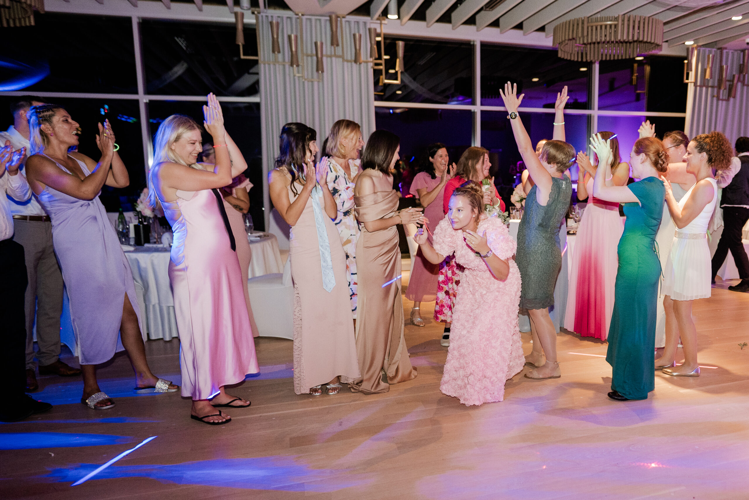 Guests celebrating on the dance floor at a wedding in the Rose hall