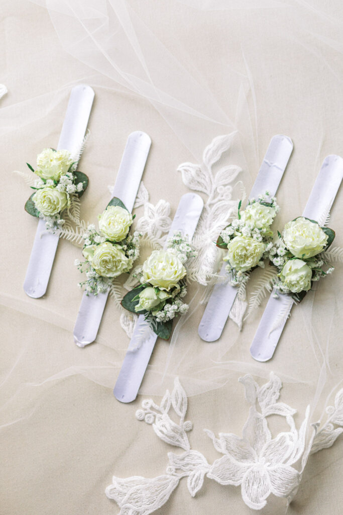 Flat lay of buttonholes and the wedding invitation